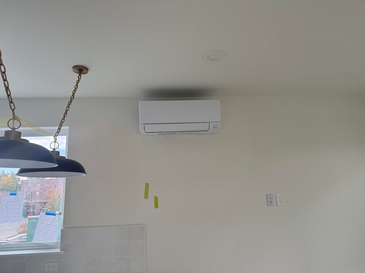 White wall-mounted ductless mini-split air conditioning unit indoors